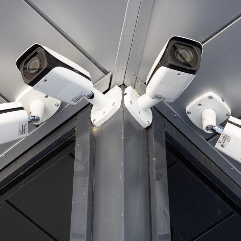 Bottom view close-up of four innovative white surveillance cameras