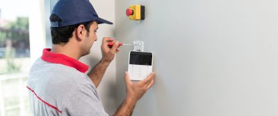 Technician set up keypad of security alarm system